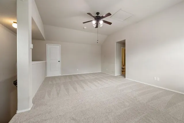 a view of a livingroom with a ceiling fan and window