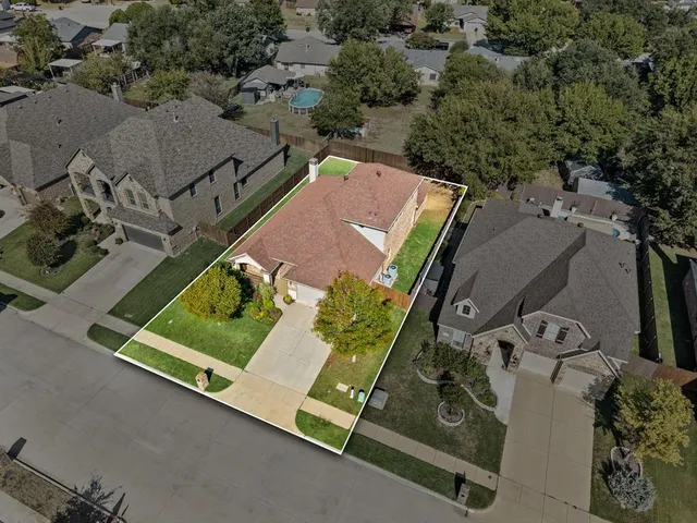 an aerial view of a residential houses with outdoor space