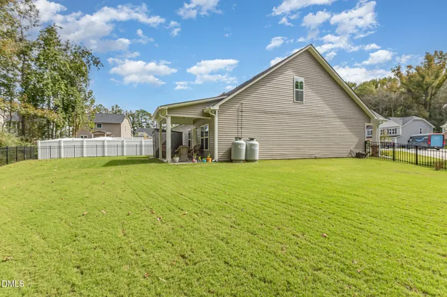 a view of a house with a backyard and a patio