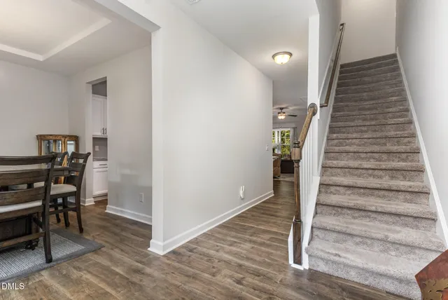 a front view of a house with yard and green space
