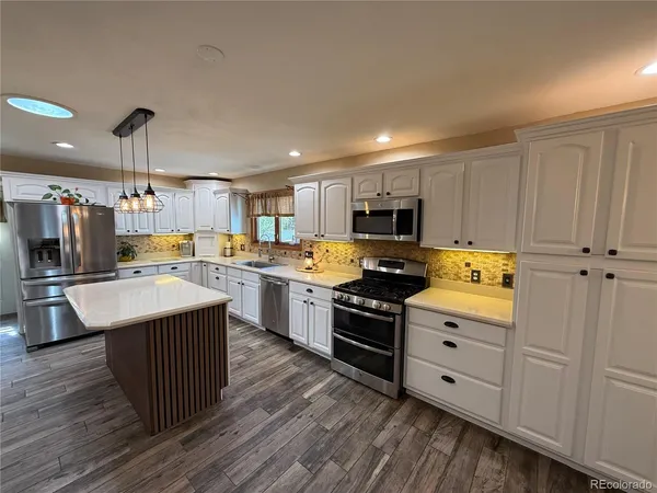 a kitchen with a sink appliances and cabinets