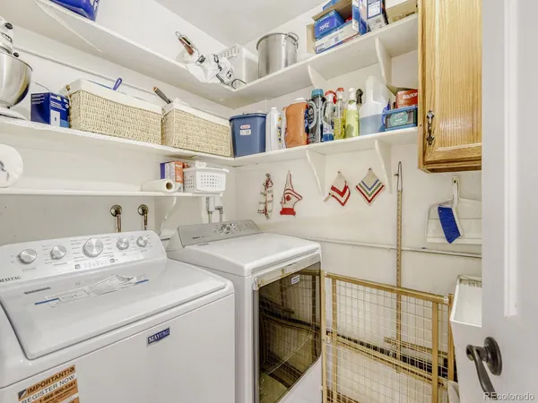 a utility room with dryer washer and a fridge