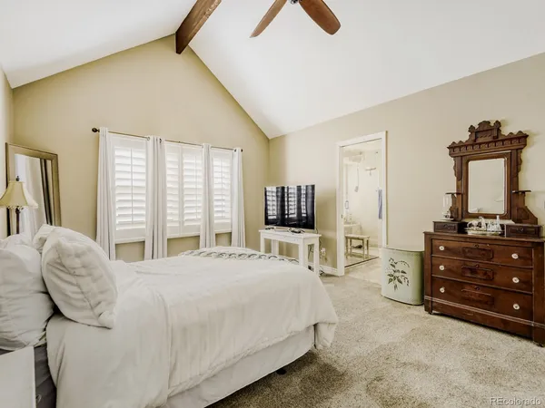 a bedroom with a bed and a television