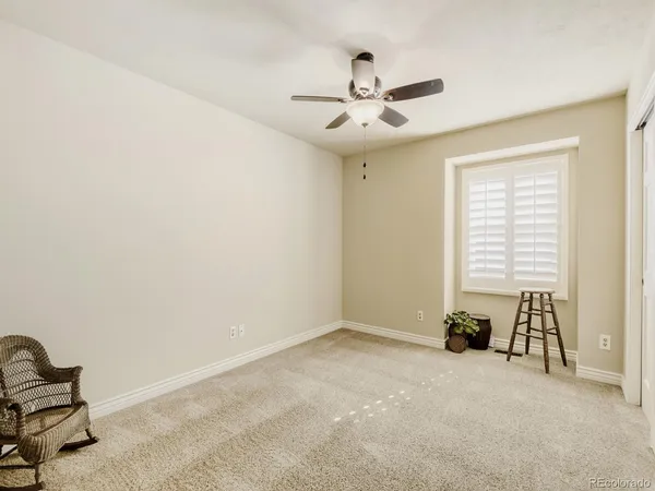 a view of a livingroom with a ceiling fan and a window