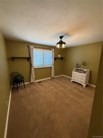 a bedroom with furniture and a ceiling fan