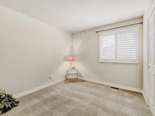 a view of a room with furniture and a window