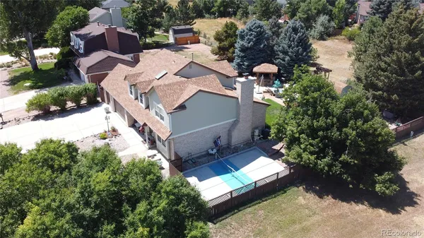 a view of a swimming pool and lounge chairs in patio