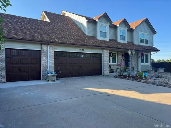 a front view of a house with yard