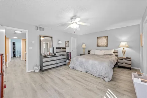 an aerial view of a house with a yard and lake view