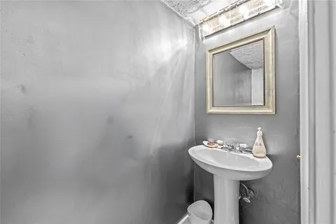 a kitchen with stainless steel appliances granite countertop a stove top oven a sink dishwasher a dining table and chairs with wooden floor