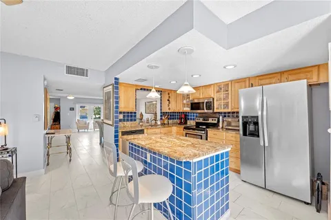 a living room with furniture a chandelier and a window