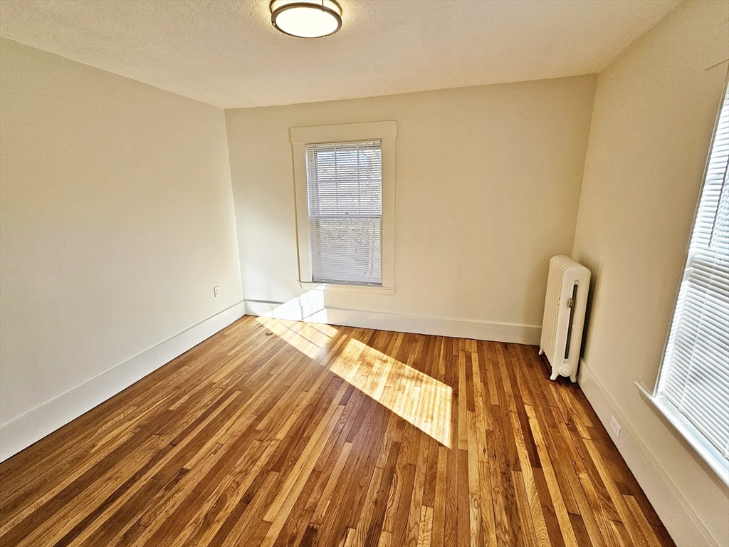 11 Channing Street, Unit 2 Newton, MA 02458 - Photo 14 of 27 a view of wooden floor in a room