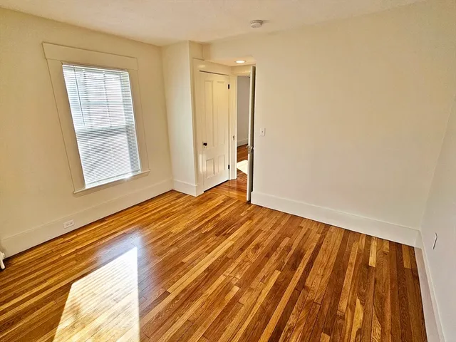 a view of an empty room and wooden floor
