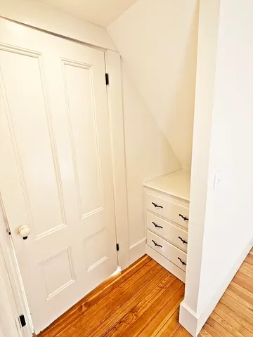 a view of a bedroom with wooden floor