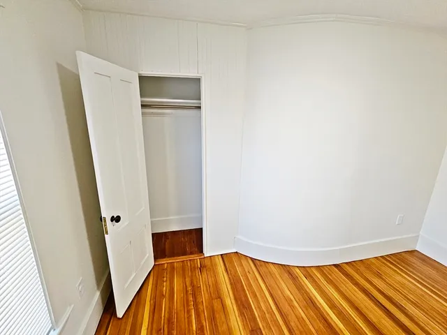 a view of a room with wooden floor and entryway