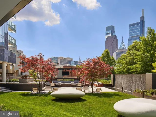a view of a house with yard and sitting area