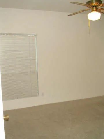 a view of a room with a hanging light and kitchen