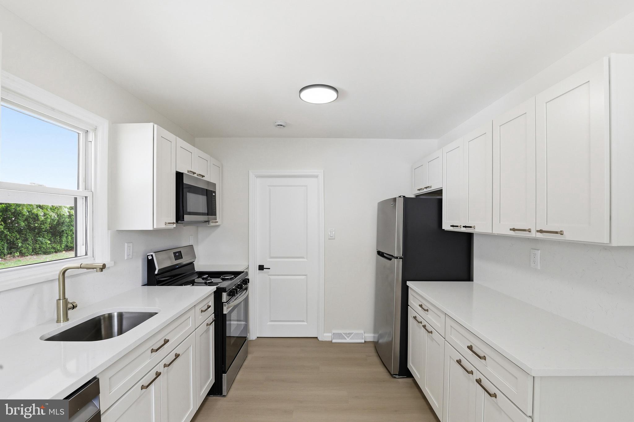 710 East Gibbsboro Road Lindenwold, NJ 08021 - Photo 11 of 21 a kitchen with white cabinets and stainless steel appliances