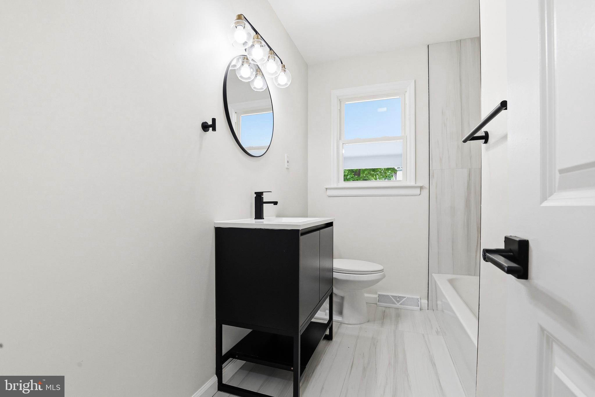 710 East Gibbsboro Road Lindenwold, NJ 08021 - Photo 15 of 21 a bathroom with a toilet a sink and a mirror