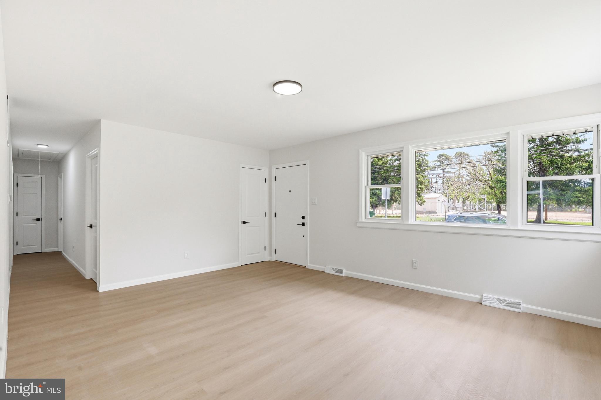 710 East Gibbsboro Road Lindenwold, NJ 08021 - Photo 8 of 21 an empty room with wooden floor and windows