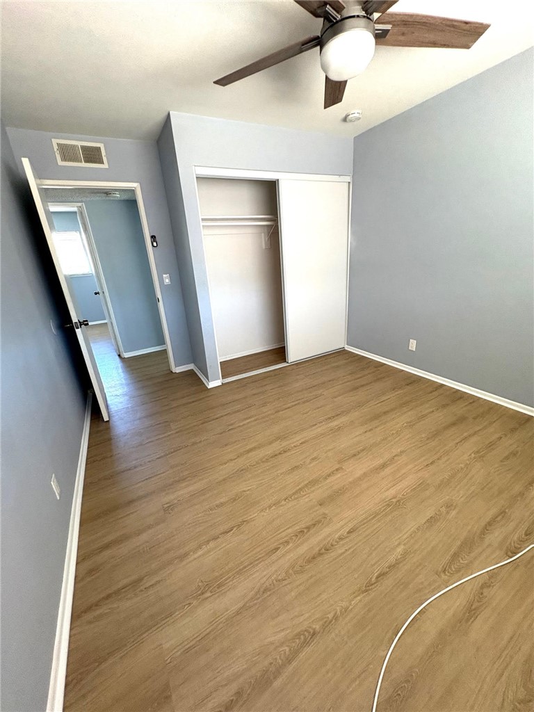 504 Heyer Street Lancaster, CA 93534 - Photo 6 of 8 a view of an empty room with window and wooden floor