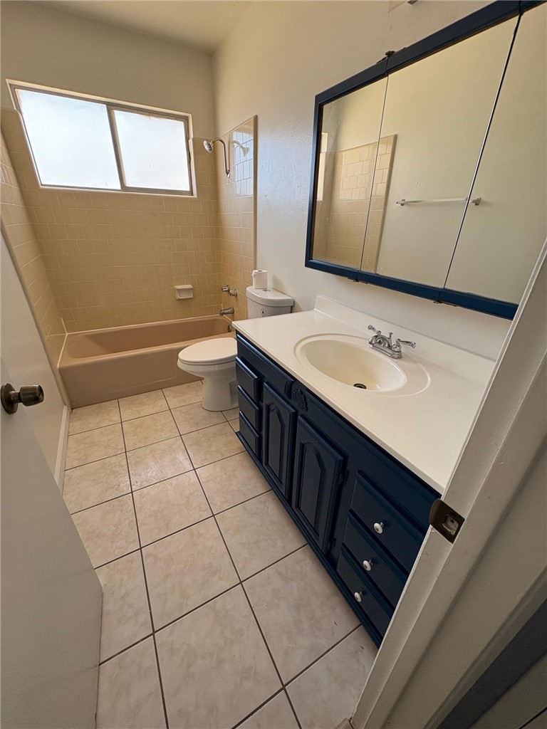504 Heyer Street Lancaster, CA 93534 - Photo 7 of 8 a bathroom with a sink a toilet and mirror