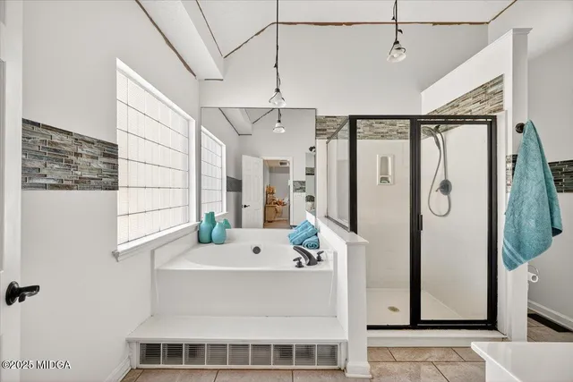 a bathroom with a bathtub a sink and a mirror
