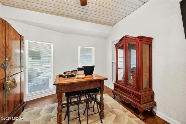 a dining room with furniture and wooden floor