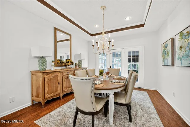 a dining room with furniture a rug and wooden floor