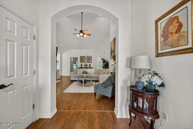 a living room with furniture and wooden floor
