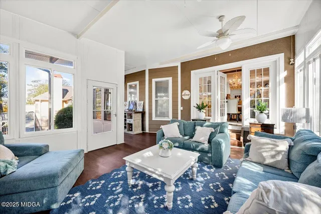 a living room with furniture and large windows