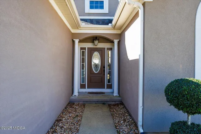a view of a hallway with wooden floor and a carpet