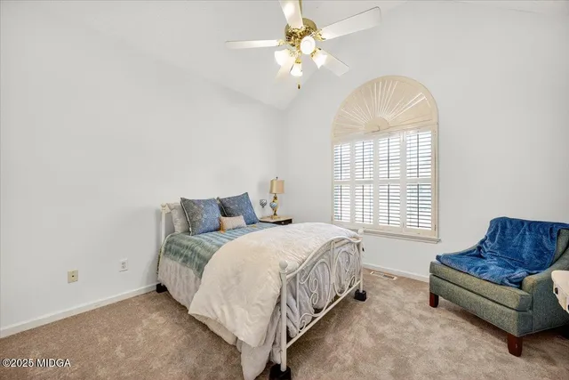 a spacious bedroom with a bed and a couch