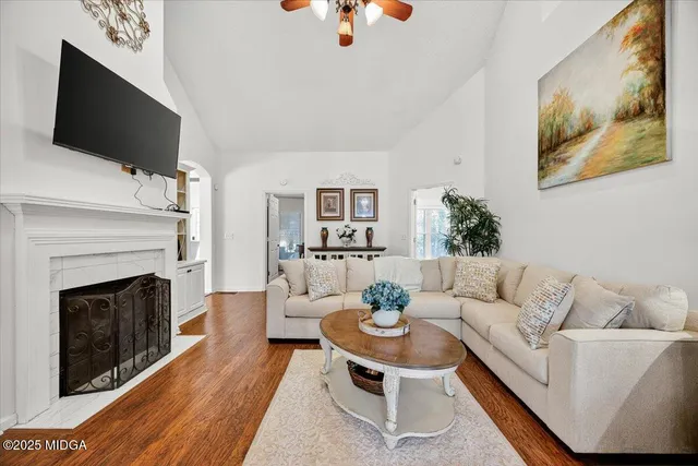 a living room with furniture and a fireplace