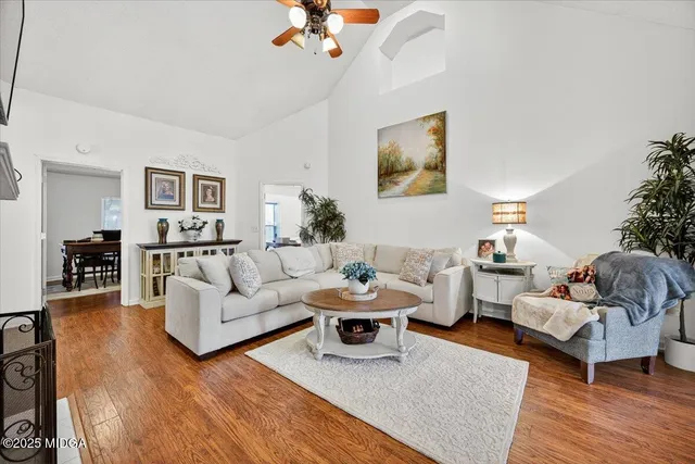 a living room with furniture and wooden floor