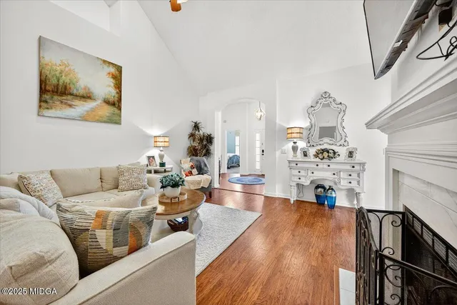 a living room with furniture and wooden floor