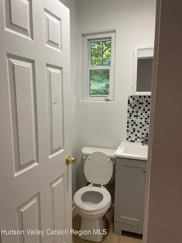 a white toilet sitting next to a bathroom sink