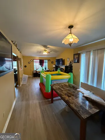 a dining room with furniture and a kitchen view