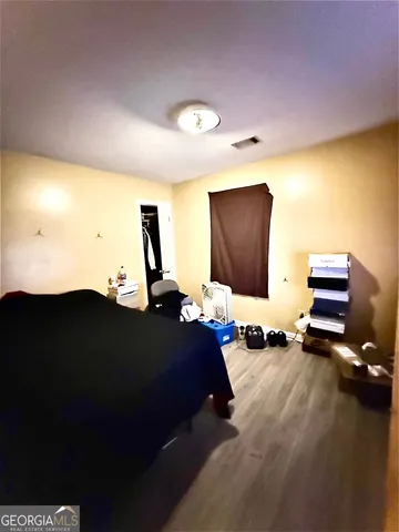 a bedroom with bed and a flat screen tv