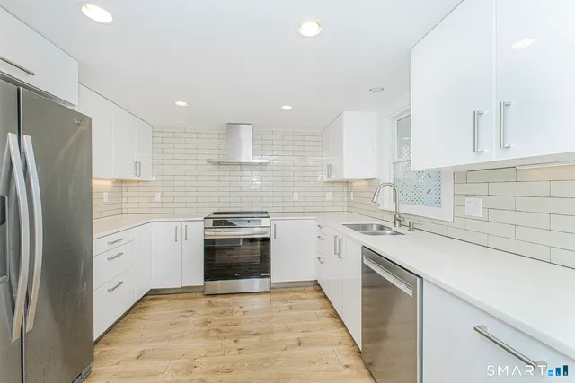 a kitchen with a sink stove and refrigerator