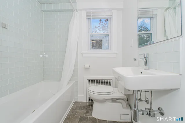 a bathroom with a sink a toilet and bathtub