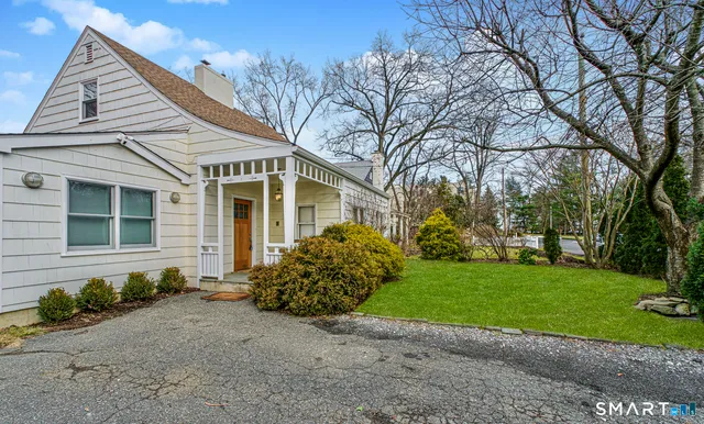 a front view of a house with a garden and yard