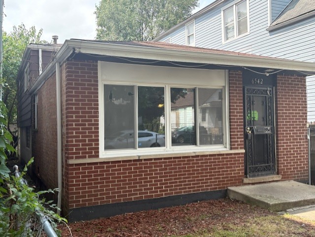 6542 South Carpenter Street Chicago, IL 60621 - Photo 1 of 17 a view of a brick house with large windows