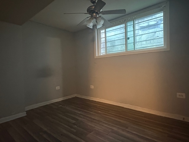 6542 South Carpenter Street Chicago, IL 60621 - Photo 11 of 17 an empty room with wooden floor chandelier fan and windows