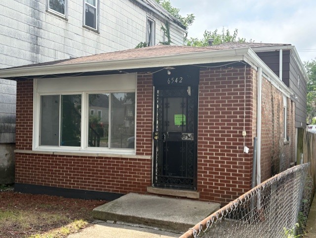 6542 South Carpenter Street Chicago, IL 60621 - Photo 17 of 17 a view of a house with a door and a window