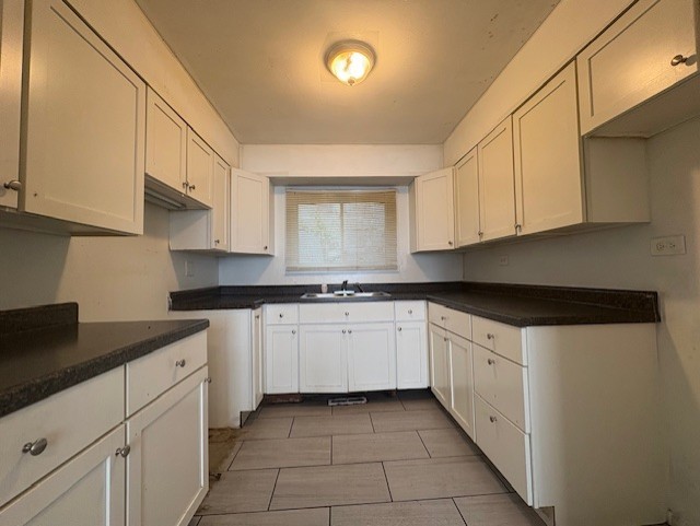 6542 South Carpenter Street Chicago, IL 60621 - Photo 5 of 17 a kitchen with granite countertop white cabinets and stainless steel appliances