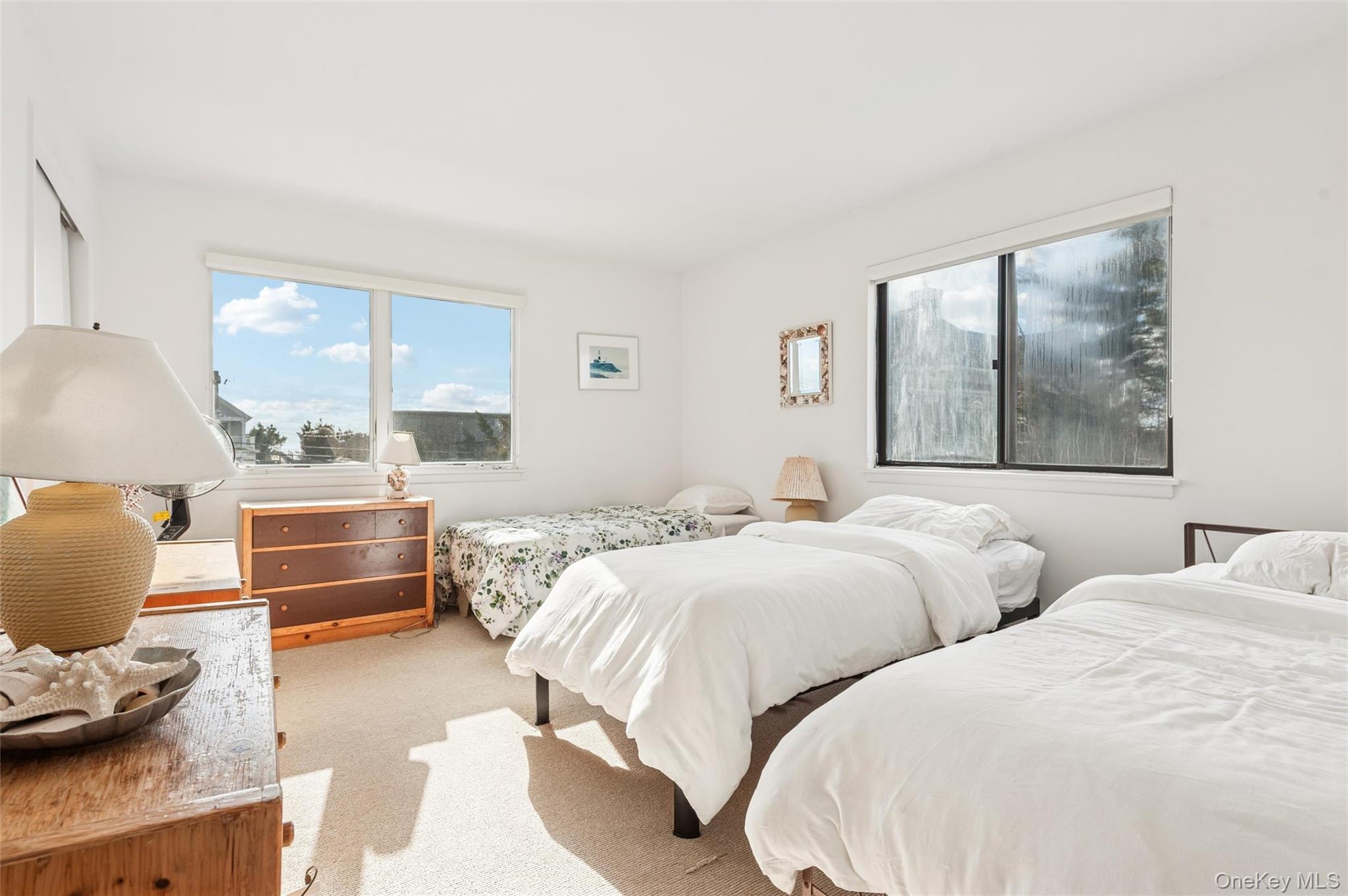 630 Dune Road Westhampton, NY 11978 - Photo 9 of 14 a bedroom with two beds and painting on the wall