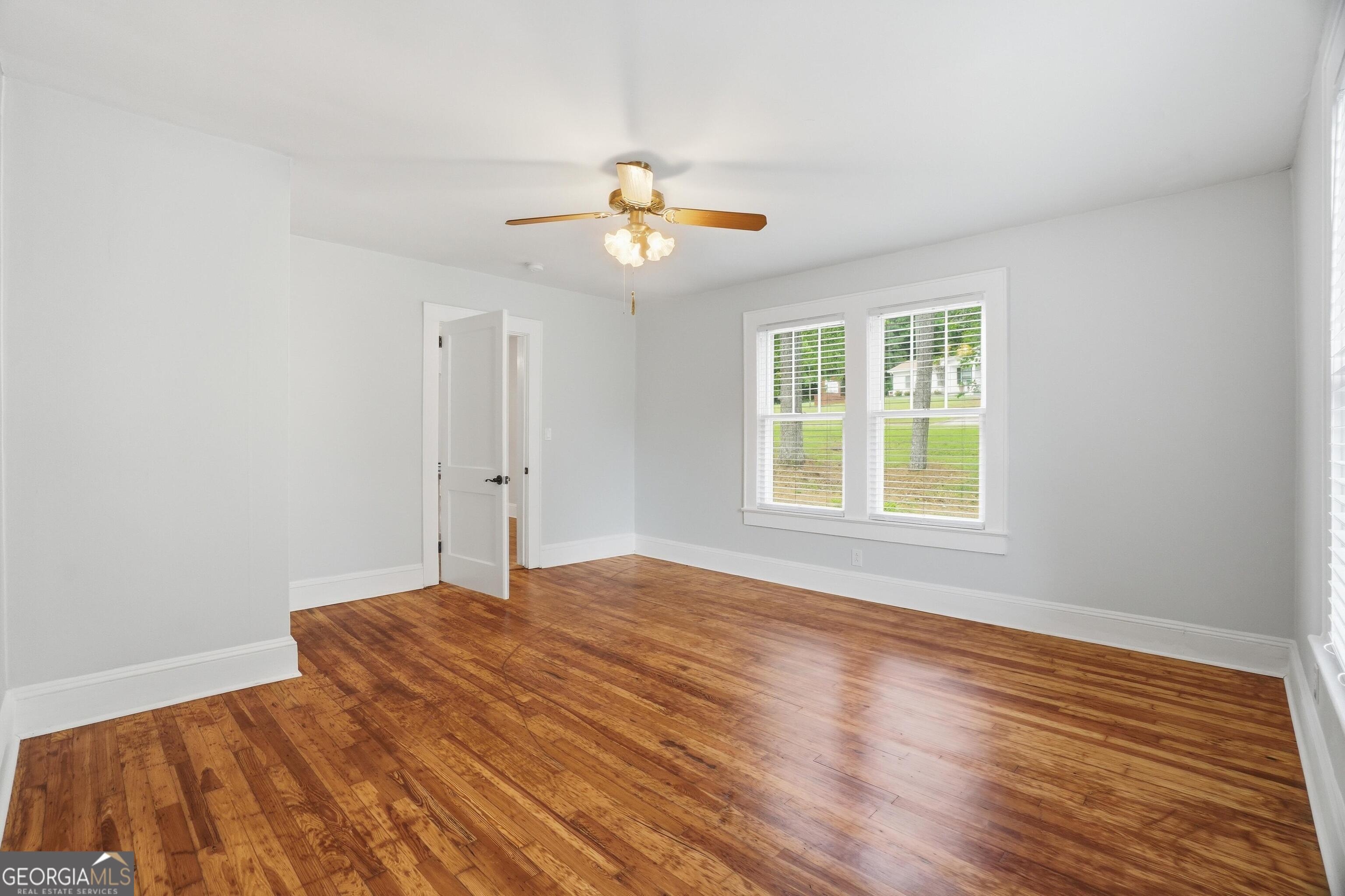 3022 Maple Road Southeast Lindale, GA 30147 - Photo 8 of 29 wooden floor in an empty room with a window