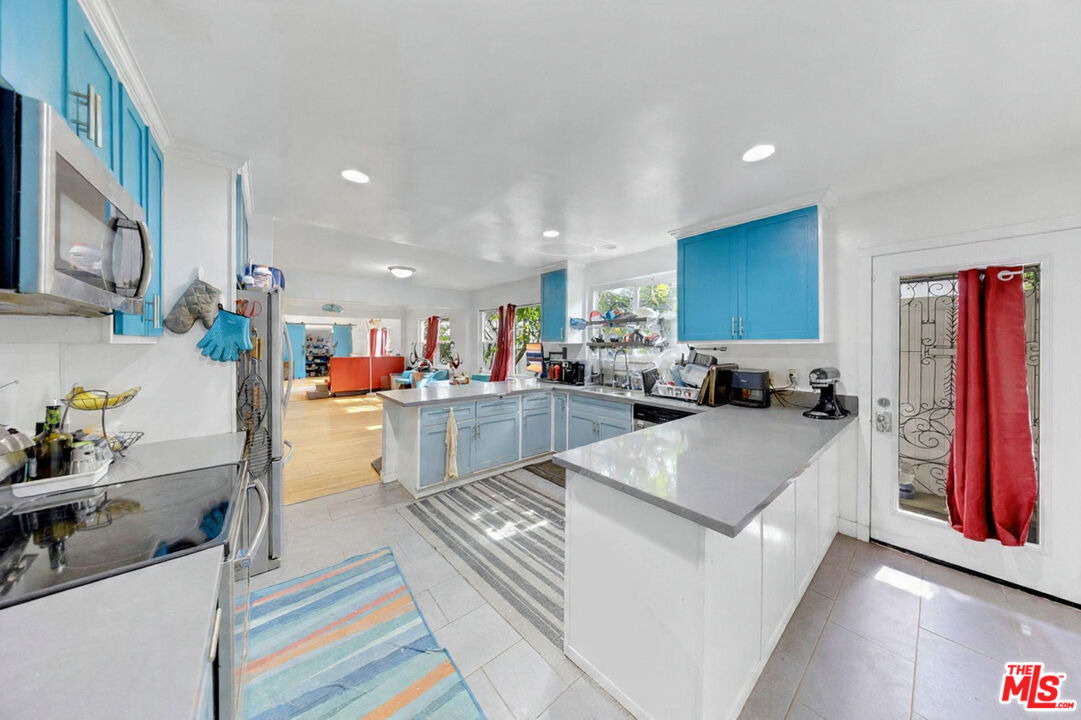 8600 La Tuna Canyon Road Sun Valley, CA 91352 - Photo 19 of 60 a view of kitchen with kitchen island stainless steel appliances refrigerator stove microwave and sink
