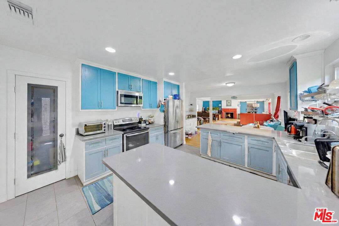 8600 La Tuna Canyon Road Sun Valley, CA 91352 - Photo 20 of 60 a kitchen with a sink and white cabinets